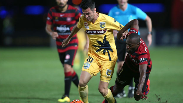 Luis Garcia challenges for the ball with Wanderers winger Romeo Castelen.